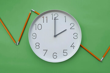 Business time. 2 o'clock. Clock and Profit Growth Chart. white clock dial and broken line graph drawn with pencils on green background. Business development concept. Flat lay