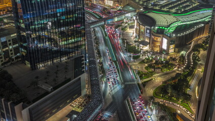 Fototapeta na wymiar Aerial panorama of Downtown Dubai with shopping mall and traffic on a street day to night timelapse from above, UAE