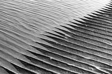 Sand structures with ripples at low tide on the beach of Juist island, Germany in National Park...