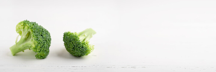 Fresh green broccoli on a white wooden background. Banner with place for text.