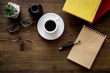 Writers author desk with books and notepad with pen, top view