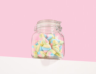 Colorful soft marshmallows in a glass jar. Sweet and delicious dessert.