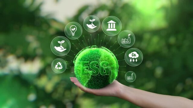 ESG icon concept. Environment, society and governance. Saving the green planet in the hands of humans on green background.