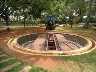 A Dramatic picture of a Manual Train Turntable for a Narrow gauge track, were used to Switch directions of a locomotive engine now displayed at Mysuru Rail Museum  in Karnataka, India.