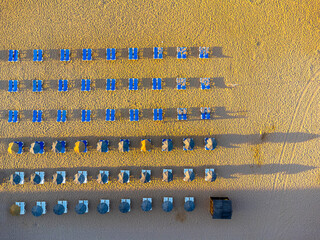 Aerial view landscape, view of an empty, clean, beautiful beach with sun loungers and umbrellas. Photo from a drone. Portugal, Albufeira, Algarve region. Praia to Tunel.