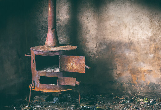 Rusty stove in abandoned room