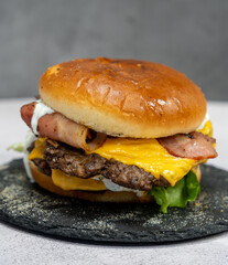Burger with meat cutlet, hamburger isolated on grey background. Tasty Hamburger. Restaurant dish. 