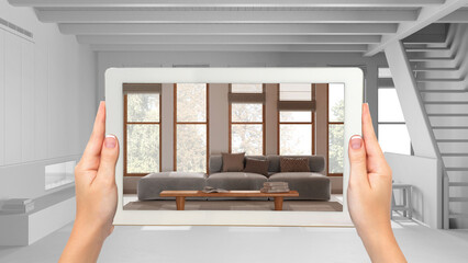 Augmented reality concept. Hand holding tablet with AR application used to simulate furniture and design products in total white background, minimal living room with staircase