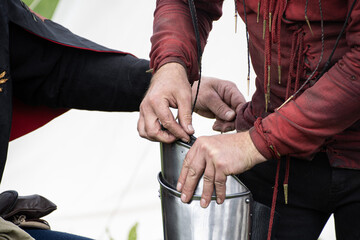 A knight  is  showing  his  squire  how  to  put  his  armour  on  before  jousting  