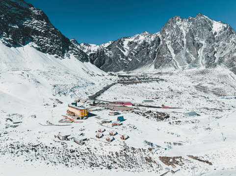 Aerial View Of Snow Capped Mountains Surrounding Portillo Ski Lodge In The Chilean Andes, Chile.