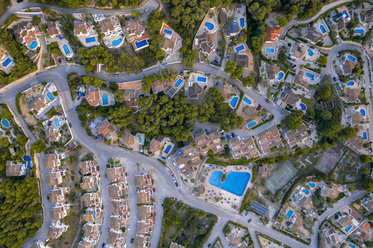 Aerial view of holiday villas with pools in a residential area, Zona Encinas, Cumbre del Sol, Alicante, Spain.