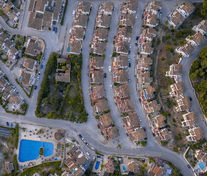 Aerial view of holiday villas with big pool in a residential area, Zona Encinas, Cumbre del Sol, Alicante, Spain.