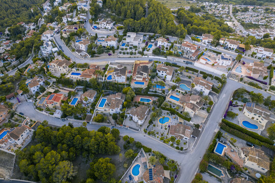 Aerial view of holiday villas with pools in a residential area, Zona Encinas, Cumbre del Sol, Alicante, Spain.