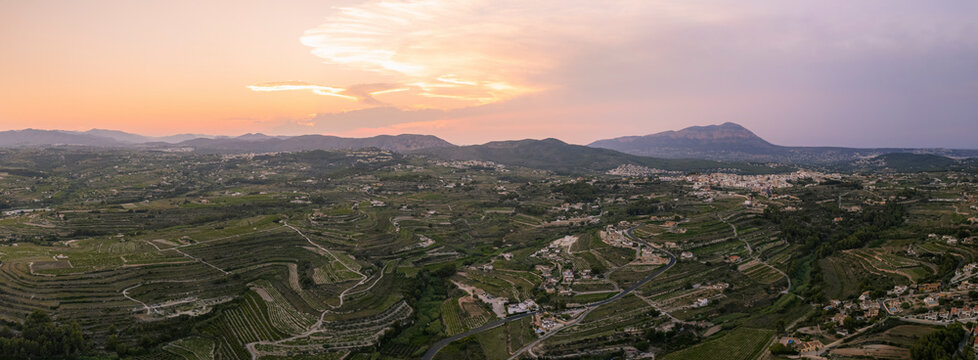 Panoramic view of a Tranquil sunset over countryside field, showcasing beauty in nature and agriculture, Zona Encinas, Cumbre del Sol, Alicante, Spain.
