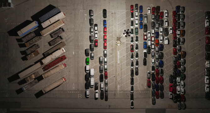 Fototapeta Aerial view of a big parking area with camions and cars at night in Grao, Valencia, Spain, Grao, Valencia, Spain.