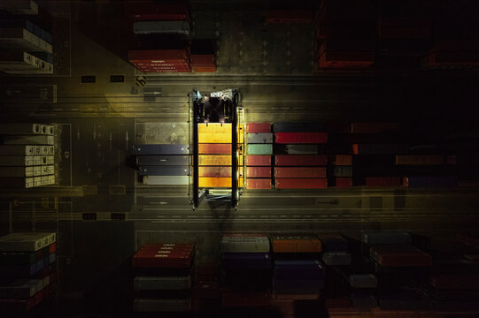 Aerial view of containers at night in the harbor area Grao, Valencia, Spain.