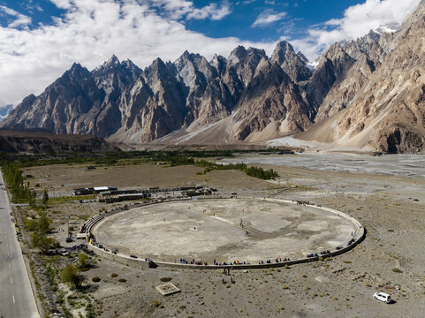 Aerial view of cricket match with Passu Cathedral right in back, Passu, Hunza Valley, Himalayas, Pakistan.
