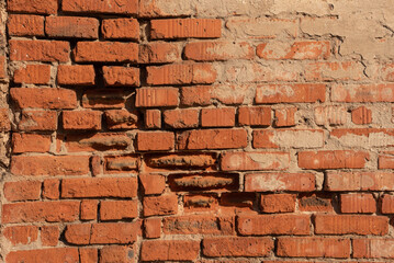 The texture of an old red brick stone wall.