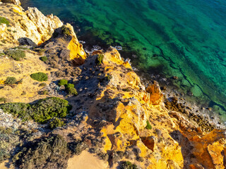 Aerial view landscape, view of an empty, clean, beautiful rocky beach. Photo from a drone. Portugal, Lagos, Algarve region.