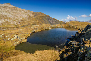 alpine pond near Lago Retico at the boarder of Ticino and Surselva, Switzerland