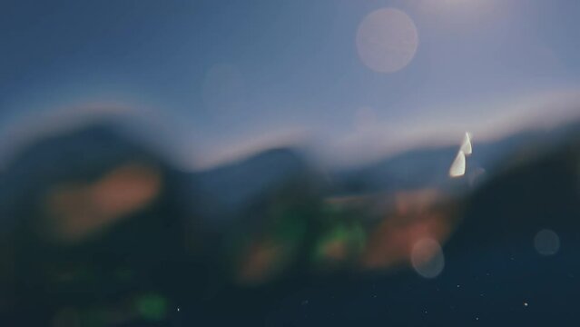 Camera slowly descends to subsurface of blue water in Mediterranean Sea, Greece