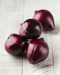 Sweet red onion on a white wooden background. Healthy food, vegetables.