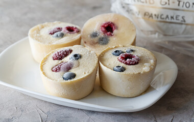 Frozen batter with berries for pancakes are homemade preparation or trendy ice cube pancakes