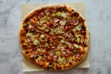 Delicious pizza with sausage, tomatoes and cheese