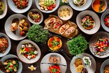 there are a lot of dishes on the wooden table