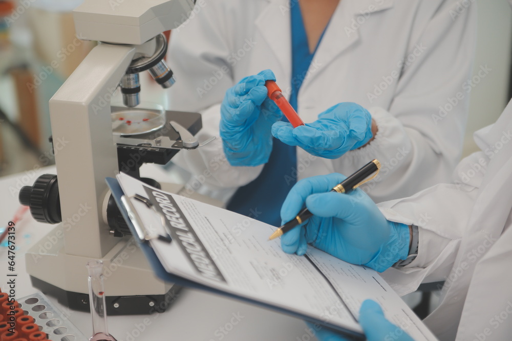 Wall mural health care researchers working in life science laboratory. young female research scientist and seni