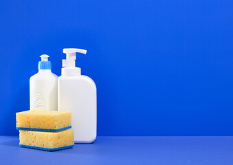Dish detergent and dishwashing sponges. Copy space for text.