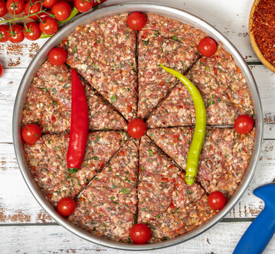 Minced meat tray kebab on wooden background. Tray kebab, famous in Hatay city of Turkey. Flavors of Turkey. Top view