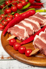 Raw lamb tenderloin on wood background. Raw lamb tenderloin with herbs and spices. Close up