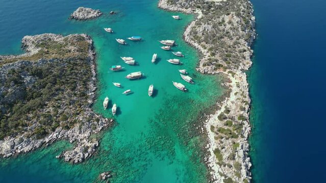 Drone view of Kekova, tour boats and people swimming. Demre, Antalya, Turkiye