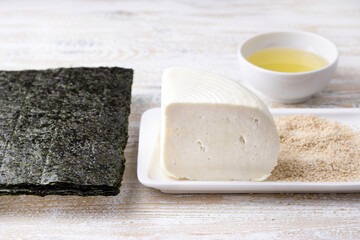Fresh cheese, nori, sesame seeds and vegetable oil - ingredients for preparing a delicious vegetarian dish