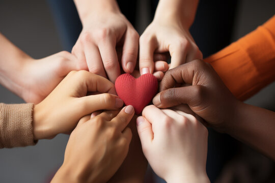 Captivating close-up of diverse hands, adorned with unique rings, shaping a heart. Radiates unity, love and multicultural harmony against a plain background.