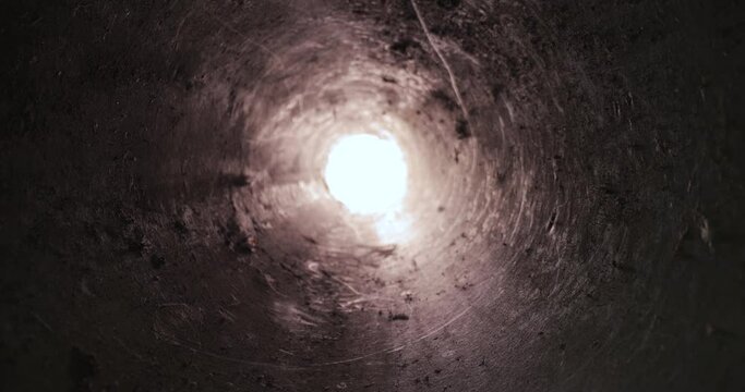 Dirty tube hole motion towards bright light source end of pipe