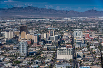 aerial landscape view of famous Downtown Las Vegas around Fremont Street, with mountains in...