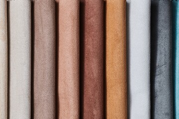 Colorful samples of upholstery fabrics close-up. Leather and suede for furniture renovation