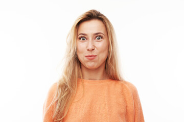 Portrait of young blond woman puffing cheeks with funny face isolated on white studio background. Humor concept, mouth inflated with air crazy expression. - obrazy, fototapety, plakaty