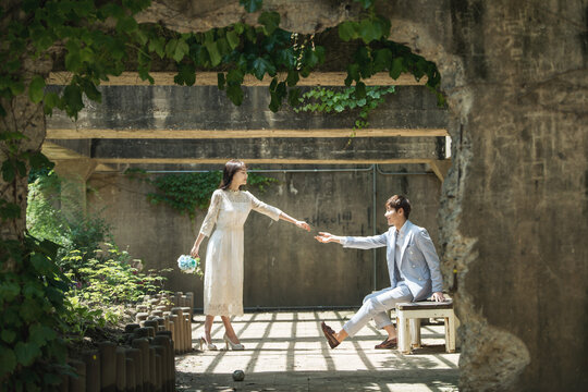A loving couple is taking wedding photos outdoors for their wedding.