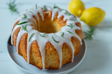 Lemon bundt cake drizzled with powdered sugar glaze