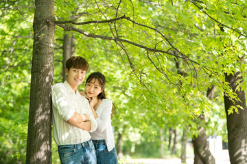 Fototapeta premium A lovely young couple are having fun in a forested park.
