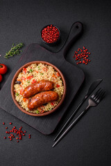 Delicious chicken or pork sausages baked on the grill with porridge and vegetables