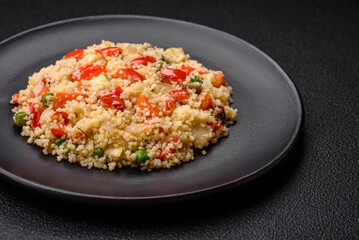 Delicious couscous porridge with cubes of grilled vegetables with salt and spices