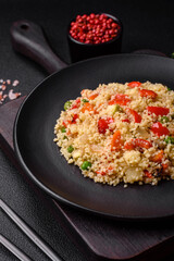 Delicious couscous porridge with cubes of grilled vegetables with salt and spices