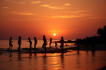 silhouettes of people on the beach