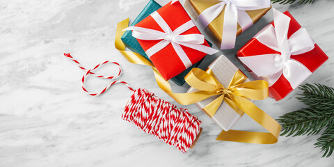 Fototapeta premium Christmas gift box, present and ribbon on white marble table