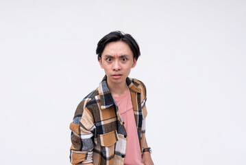 A young angry asian man looking very offended, with glaring bulging eyes. Isolated on a white...