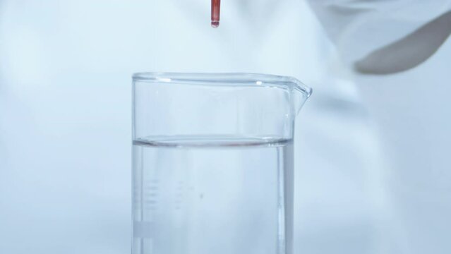 For tests requiring serum, a blood sample is drawn into a glass containing no anticoagulant. Hand of scientist holding dna test tube in laboratory.  Deoxyribonucleic acid. Complete blood count. CBC.